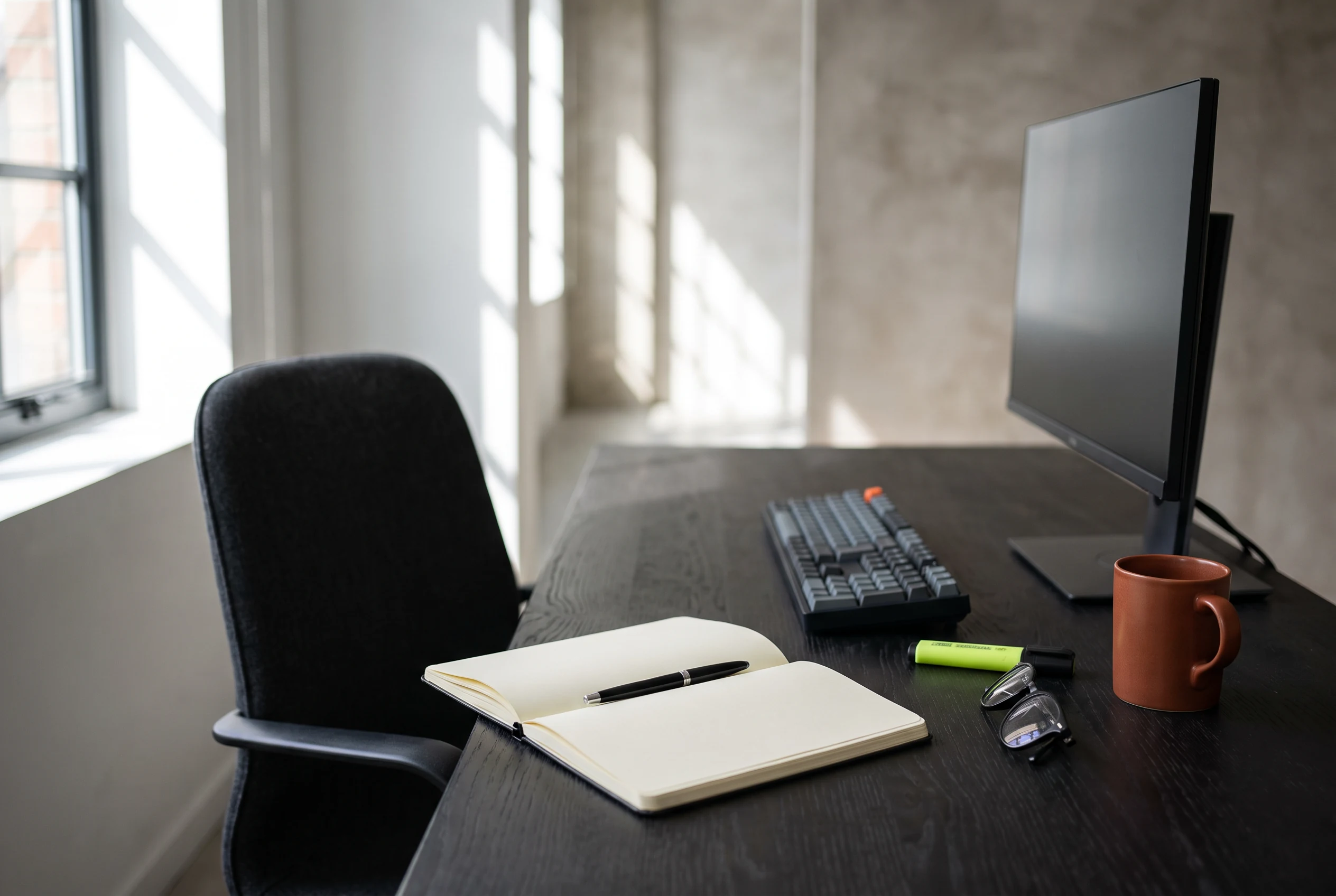 Orderly office workstation with notebook and keyboard